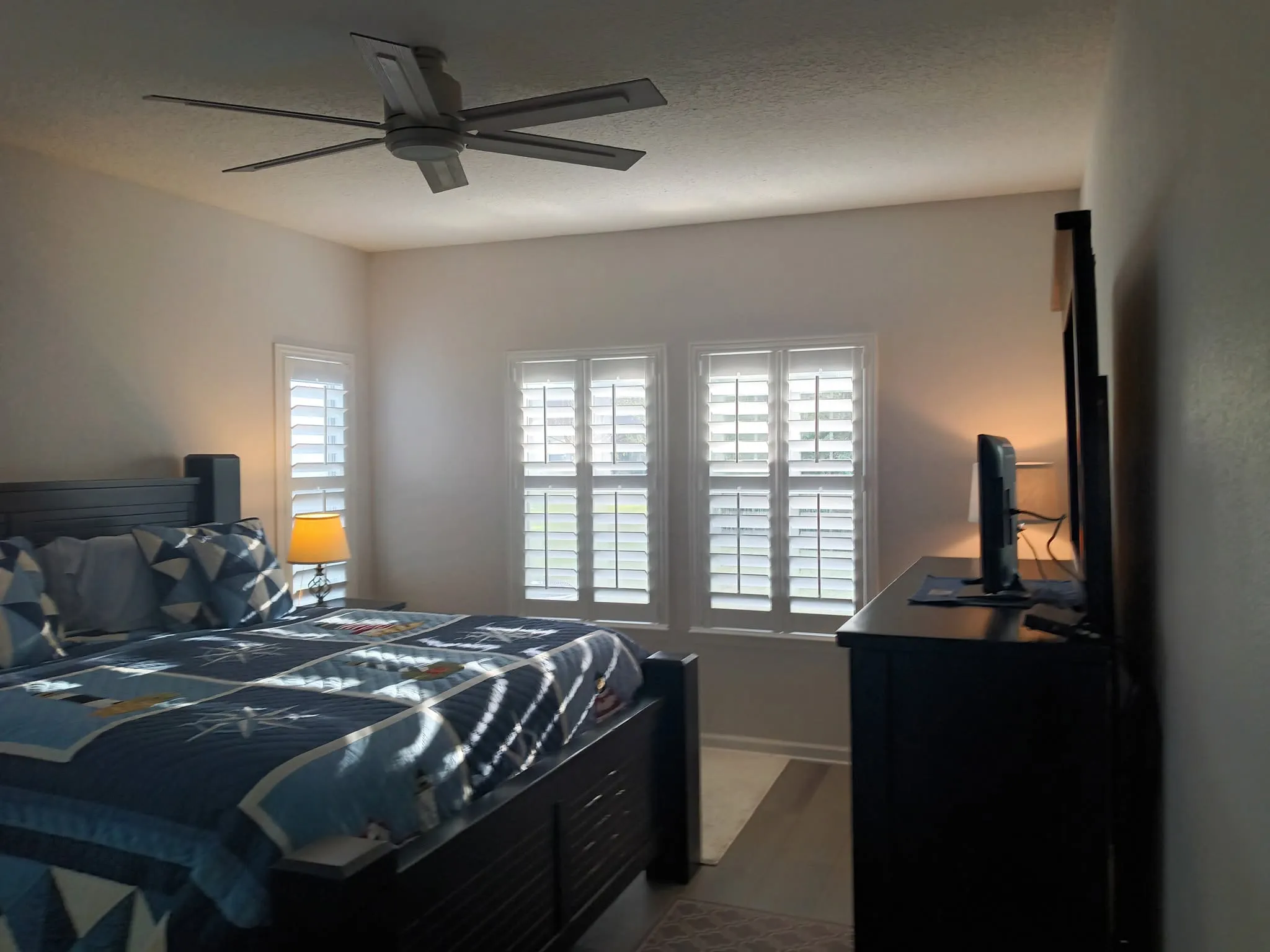 Main bedroom after repaint with crisp white trim